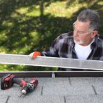 Man with safety glasses installing seamless gutters